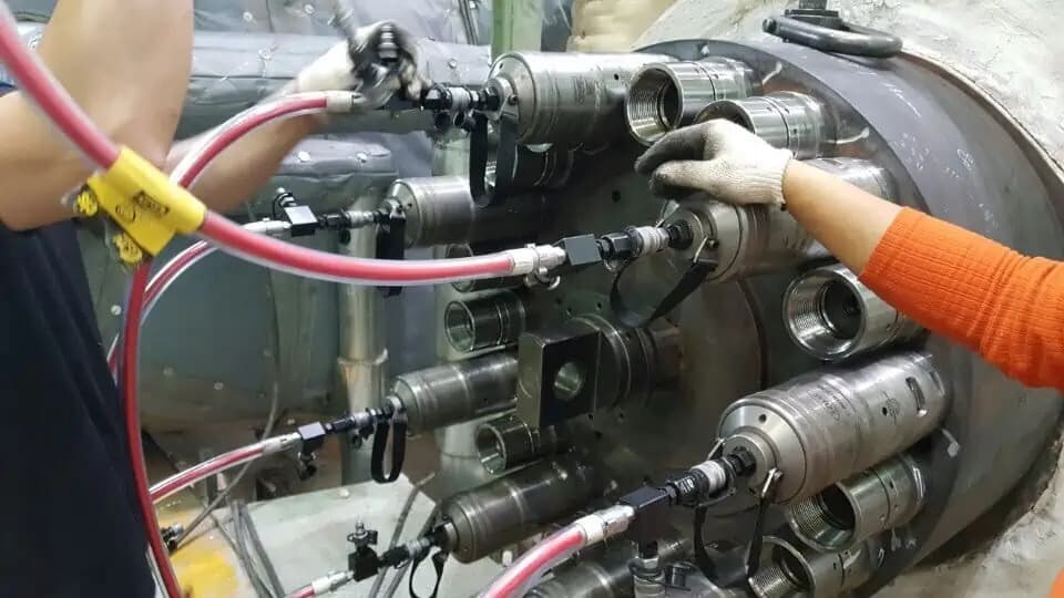 Illustrating the process of induction bolt heating on a large piece of equipment