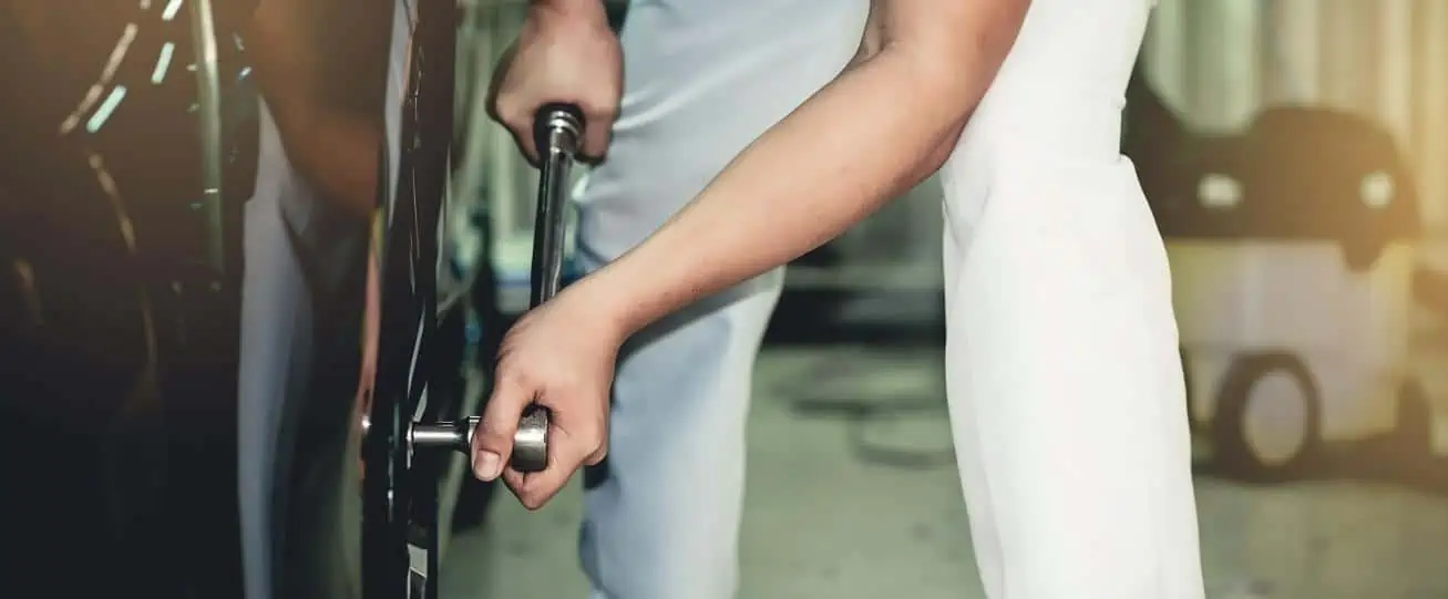 Image of a torque wrench being used by individual to tighten tire bolts